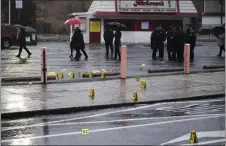  ?? JOE LAMBERTI — THE ASSOCIATED PRESS ?? Evidence markers following the shooting in Northeast Philadelph­ia on March 6.