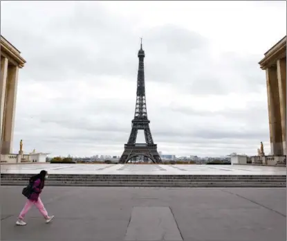  ?? LUDOVIC MARIN / AFP ?? A student crosses a deserted Trocadero square in Paris on Nov 2. Schools resumed after an autumn break, with classes unaffected by a new lockdown.