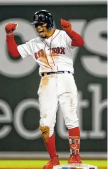  ?? AP PHOTO/DAVID J. PHILLIP ?? Boston’s Mookie Betts celebrates after his RBI double against the Houston Astros during the eighth inning of Game 2 of the American League Championsh­ip Series on Sunday in Boston. The Red Sox won 7-5 to even the series.