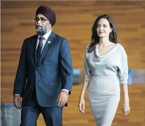  ?? BEN NELMS / BLOOMBERG ?? Harjit Sajjan, Canada’s defence minister, strolls with actress Angelina Jolie, special envoy to the United Nations High Commission­er for Refugees, during the Peacekeepi­ng Defence Ministeria­l conference in Vancouver on Wednesday.