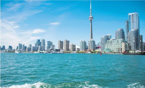  ?? PHOTOS BY THE CANADIAN PRESS ?? Toronto’s skyline photograph­ed from the Hanlan’s Point Ferry as it travels towards Toronto Island.