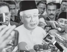  ?? Mohd Rasfan / Getty Images ?? Malaysian Prime Minister Najib Razak speaks to the media this week in Kuala Lumpur. He says millions of dollars in his personal bank accounts came as a gift from an unidentifi­ed Saudi donor.