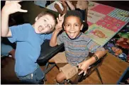  ?? File ?? This 2019 file photo shows friends making goofy faces in the after-school program at the North Broad Youth Center.