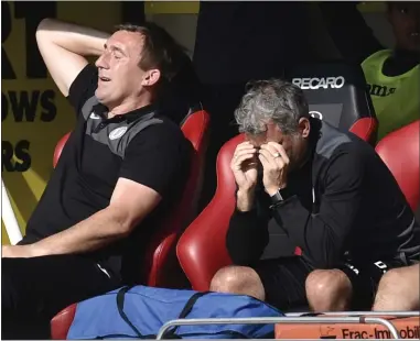  ??  ?? That sinking feeling: St Mirren manager Alan Stubbs and first-team coach Darren Jackson can’t hide their disgust at Saturday’s display