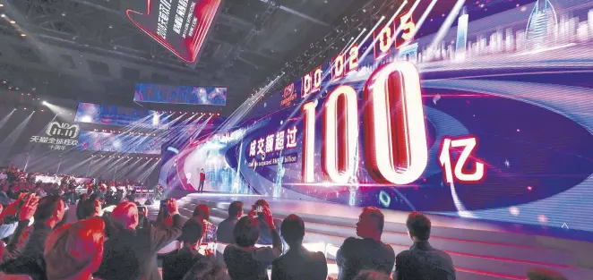  ??  ?? A screen shows the gross merchandis­e volume, a measure of sales, after two seconds of Singles Day sales, as it reaches nearly $1.44 billion during the 2018 TMall 11:11 Global Shopping Festival Gala in Shanghai, early on Nov. 11.