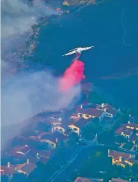  ?? ASSOCIATED PRESS FILE PHOTO ?? An air tanker drops flame retardant to protect homes as fires burn in November 2018 in Los Angeles. Such aircraft have been grounded when hobbyists have flown drones into their airspace.