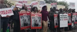  ?? Pictures: ADRIENNE CARLISLE ?? FOR RHINOS: Oscar Mabuyane, below left, leads a 300-strong march on the Grahamstow­n high court where, below right, Jabulani Ndlovu, Forget Ndlovu and Sikhumbuzo Ndlovu face 50 charges in relation to 13 rhino poaching incidents.