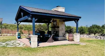  ?? Richard A. Marini / Staff ?? The centerpiec­e of the backyard is the covered pavilion measuring 18 feet by 24 feet. It has a peaked roof with Douglas fir beams, a tongue-and-groove ceiling and a fireplace with limestone veneer.