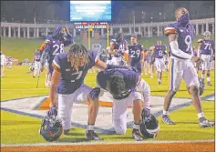  ?? Erin Edgerton The Associated Press ?? Virginia players take a knee after Saturday’s win against Abilene Christian, which failed to cover after a late intercepti­on.