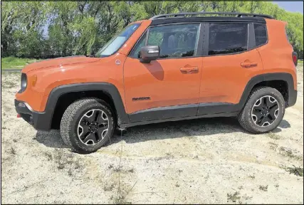  ??  ?? The 2016 Jeep Renegade Trailhawk in Omaha Orange has off-road capability but is more refined than the Wrangler.