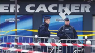  ?? (Yves Herman/Reuters) ?? FRENCH POLICE OFFICERS stand guard outside the Hyper Cacher supermarke­t in Paris on January 10, 2015.