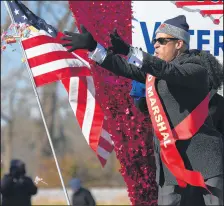  ??  ?? Lake County Assessor and parade grand marshal Jerome Prince throws candy from a float during Hammond’s Veterans Appreciati­on Day parade.