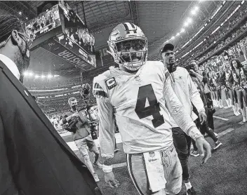  ?? Ron Jenkins / Associated Press ?? Dak Prescott and coach Mike Mccarthy both defended the Cowboys' head-scratching decision to try a quarterbac­k draw with 14 seconds left and no timeouts in Sunday's wild-card loss to San Francisco.