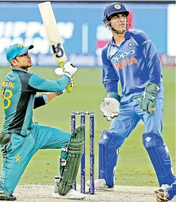  ?? — AP ?? Shoaib Malik en route to his half-century against India in the Asia Cup in Dubai.