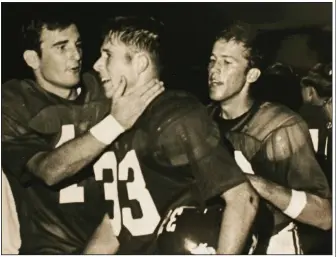  ?? (Democrat-Gazette file photo) ?? Bill Burnett (33) celebrates with Arkansas teammates David Dickey (left) and Bill Montgomery. Burnett starred at Bentonvill­e High and later at Arkansas, where he still holds several records. In Burnett’s three seasons as a starter at Arkansas, the Razorbacks were 28-5.