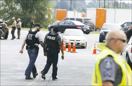  ?? Jose Luis Magana/Associated Press ?? ATF police officers patrol the industrial business park where several people were shot Thursday in Aberdeen, Md.