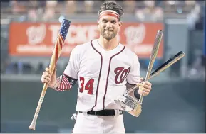  ?? ALEX BRANDON – THE ASSOCIATED PRESS ?? The Washington Nationals’ Bryce Harper holds his bat and the trophy after winning the Major League Baseball Home Run Derby on Monday.