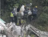  ?? RAUL ARBOLEDA, AFP/ GETTY IMAGES ?? Rescue and forensic teams recover the body of a victim of the plane crash in Colombia that killed 71 peopleMond­ay.