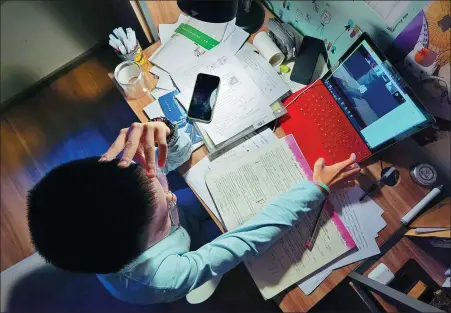  ?? ZOU DEXIN / FOR CHINA DAILY ?? A child takes classes online at home in Shenyang, Liaoning province, on Jan 12. Study-from-home regimen is part of the new normal, as the outbreak of COVID-19 has led to the growth of online education.