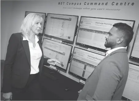  ?? DAX MELMER ?? Theresa Morris, director of emergency services at Windsor Regional Hospital, works with Sheraz Thomas, standard operating procedures co-ordinator, on Wednesday in the command centre, where staff can track patients to make better use of beds and resources.