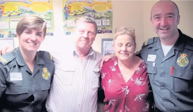  ??  ?? Kevin Perry and his wife, Paula, thank Welsh Ambulance Service crew Joanna Bevan and Richard John for saving his life