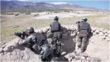  ?? RAHMAT GUL/ASSOCIATED PRESS ?? Afghan commandos are positioned at the village of Pandola on Friday near the site of Thursday’s U.S. bombing of an Islamic State tunnel complex in the Achin district of Jalalabad east of Kabul, Afghanista­n.