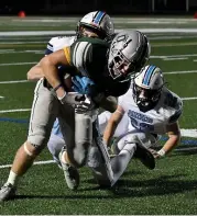  ?? MARK STOCKWELL - BOSTON HERALD ?? Duxbury High running back Jack Rees gets tackled by Franklin’s Brendan Larivee and Cody Howard (22).