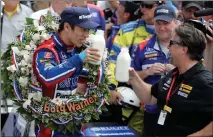  ?? Associated Press photo ?? Takuma Sato, left, of Japan, toasts with car owner Michael Andretti as they celebrate after winning the Indianapol­is 500 auto race at Indianapol­is Motor Speedway, Sunday.