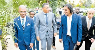  ?? CONTRIBUTE­D ?? Prime Minister Andrew Holness (second left) in dialogue with founder and Chief Executive Officer of Amber Group, Ambassador Dushyant Savadia (second right), on arrival for the launch of the Amber UTech Launchpad at the University of Technology (UTech) campus in Papine, St Andrew, on March 6. Accompanyi­ng them are President of UTech Dr Kevin Brown (left) and Pro-Chancellor of UTech Aldrick McNab (right).