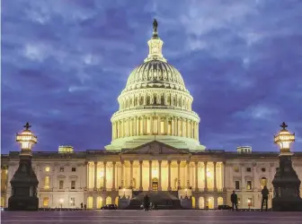  ?? AP FILE PHOTO ?? ‘ROUTINE PRACTICE’: Lights shine inside the U.S. Capitol Building as night falls in Washington. Dozens of web addresses implying U.S. senators were ‘for sale’ have been quietly and mysterious­ly purchased online.