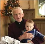  ?? COURTESY OF MOROSKI FAMILY ?? Hank Moroski holds Henry Whitman, one of his seven great-grandchild­ren, during the holidays several years ago.