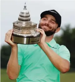  ??  ?? POTOMAC: Kyle Stanley holds the trophy after the Quicken Loans National golf tournament, Sunday, in Potomac, Md. Stanley won in a playoff. —AP