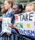  ?? PICTURE: MUTINY MEDIA ?? NO MORE: Pupils from St Teresa’s School in Rosebank brave rain and traffic to take a stand against racism in South Africa.