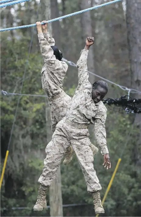  ?? Scott Olson / Gett y Imag es files ?? U.S. Marine recruits navigate boot camp in South Carolina. Queen’s University and FEI Canada have
teamed up on a boot camp for chief financial officers that aims to improve their leadership skills.