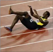  ?? FRANK AUGSTEIN — THE ASSOCIATED PRESS ?? Usain Bolt lays on the track after falling in the men’s 4x100m relay final at the World Athletics Championsh­ips in London on Saturday.