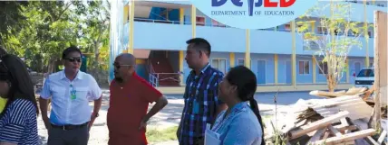  ??  ?? Provincial Administra­tor lawyer Mark Tolentino (in white polo) and Catmon Mayor Dan Jusay, together with officials from Cebu Province and Catmon Integrated School, check on the constructi­on of school buildings funded by the Cebu provincial government...