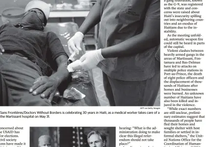  ?? VALERIE BAERISWYL AFP via Getty Images ?? Médecins Sans Frontières/Doctors Without Borders is celebratin­g 30 years in Haiti, as a medical worker takes care of a patient at the Martissant hospital on May 31.