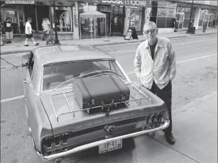  ?? Photos by Joseph B. Nadeau ?? Jim McDonald is pictured with his 1967 Mustang, which features a rare optional luggage rack on the rear deck.