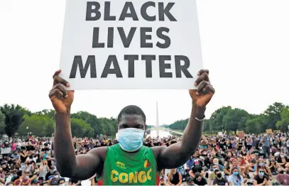  ?? Picture: Reuters ?? TURNING POINT. A person holds a placard as demonstrat­ors gather at the Lincoln Memorial in Washington on Thursday during a protest against the death in police custody of George Floyd.