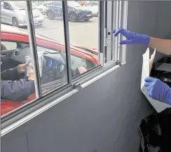  ??  ?? The new drive-through pharmacy in Maidstone allows patients or their relatives to pick up medicine. Right: Joanne Martin, senior pharmacy technician in Oncology Pharmacy