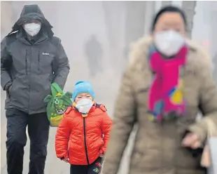  ?? Picture: Getty Images. ?? Masked residents in Jinan, Shandong Province, take action to cope with the smog there.