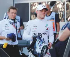  ?? Reuters ?? Mercedes’ driver Valtteri Bottas walks back to the pit after qualifying in pole position at the Russian Grand Prix in Sochi.