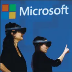  ?? ELAINE THOMPSON — THE ASSOCIATED PRESS ?? Members of a design team at Cirque du Soleil demonstrat­e use of Microsoft’s HoloLens device in helping to virtually design a set at the Microsoft Build 2017 developers conference in Seattle.
