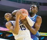  ?? MATT SLOCUM/AP ?? Creighton’s Arthur Kaluma, right, and Villanova’s Jordan Longino struggle for a rebound during the second half Saturday in Philadelph­ia.