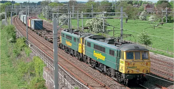  ??  ?? Slindon, just north of Stafford, is the location of this view of No. 86607 and No. 86621, taken on May 28, 2010. Detail difference­s between the two locomotive­s include roofmounte­d fire extinguish­er bottles, pantograph­s and the liveries, which have slightly different colour shades in the logos and yellow paint.