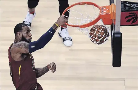  ?? STEVE RUSSELL TORONTO STAR ?? Cleveland Cavaliers forward LeBron James dunks against the Raptors at Air Canada Centre in Toronto on Tuesday night during Game 1 of their best-of-seven Eastern Conference semifinal series. For the game result and more NBA playoff news, see...