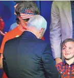  ??  ?? Vice President Mike Pence talks to Zeke Pirtle, 7, as he greets supporters who sat behind him during a speech at a campaign rally Friday in Roswell for Republican candidates Steve Pearce and Yvette Herrell.