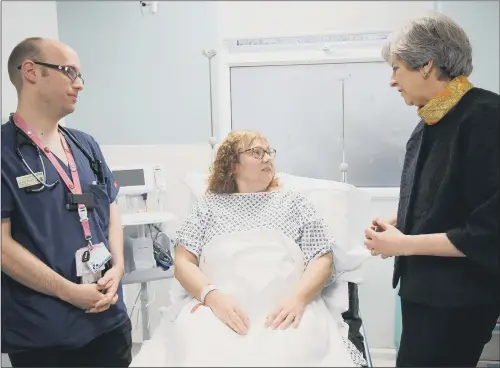  ??  ?? FRONT LINE: Prime Minister Theresa May speaks to patient Sandra Dunn as she visits Frimley Park Hospital near Camberley in Surrey. PICTURE: TOBY MELVILLE/PA WIRE.