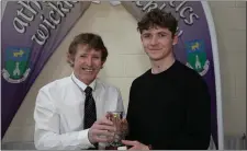  ??  ?? Ronan Dempsey of Greystones AC is presented with the Junior Men Star Award by Bill Porter.