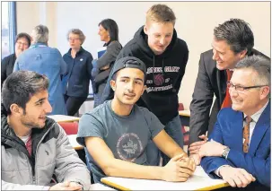  ?? SUBMITTED PHOTO ?? Education Ministers Jordan Brown and Economic Developmen­t Minister Heath MacDonald (far right) chat with students after announcing Wednesday new teachers and English as a second language resources for Charlottet­own area schools.